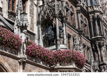 The facade of the New Town Hall is decorated with flowers. Marienplatz square. Munich, Germany