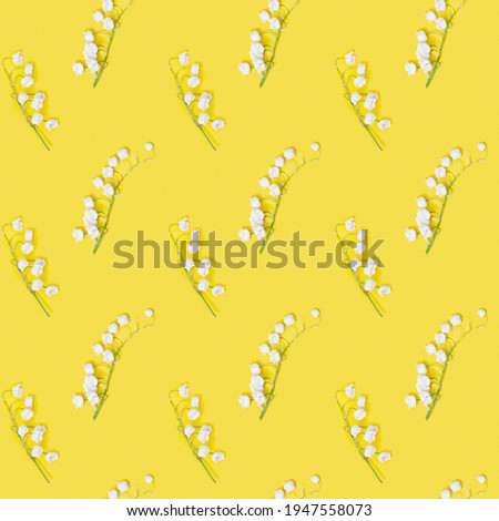 Spring geometric pattern with white lily of the valley flowers blooming  on yellow background. Seasonal styling, botanical floral print.