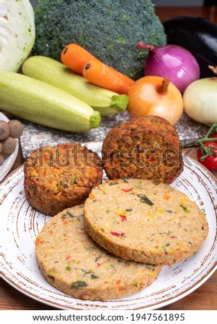 Round vegetarian patties or burgers made from grains, soybeans, vegetables and legumes