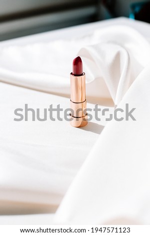 Red glamour luxury lipstick on a silk background, for luxury lifestyle, luxury mood and glamour Instagram feed