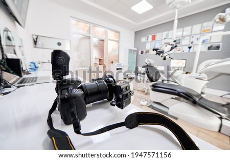 Dental office with professional camera, laptop and medical equipment.
