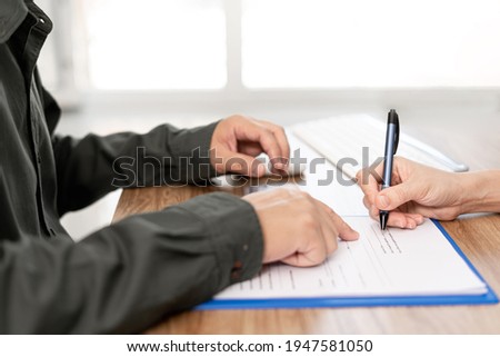 Women sign contact  in document  with Insurance agent on clipboard while examining working process Insurance concept