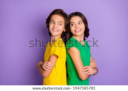 Photo of two brunette happy brother and sister stand back to back arms crossed isolated on violet color background