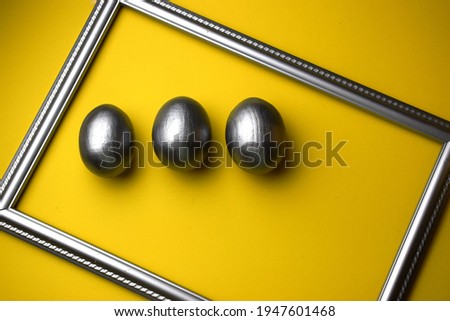 Easter card with grey eggs  on classic yellow background. Copy space. Color of the year 2021.