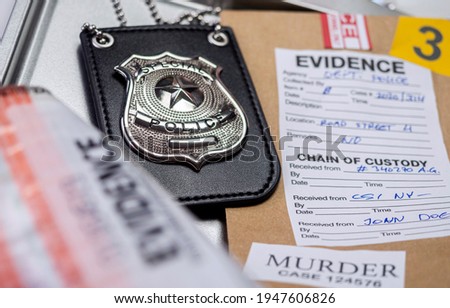 Police badge next to evidence bag, concept image