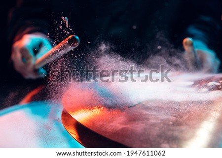 Drummer's rehearsing on drums before rock concert. Man recording music on drumset in studio Royalty-Free Stock Photo #1947611062