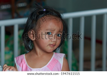 Portrait of asian baby girl toddler, Face looking glancing at camera  in home