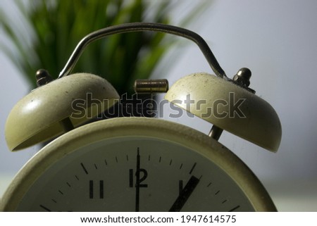 an alarm clock with a dusty bell