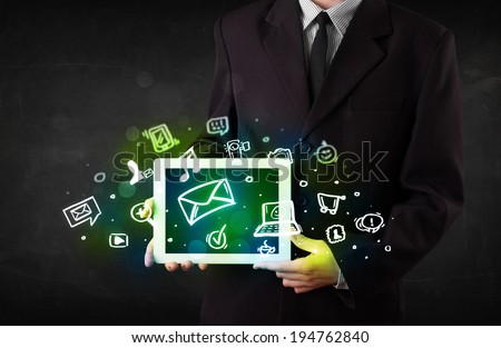 Person holding a white tablet with media icons and symbols