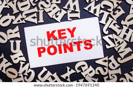 On a light background, wooden letters of the English alphabet and a white card inside with the words KEY POINTS