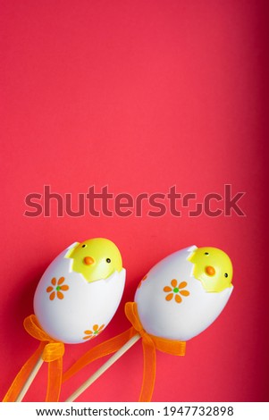 Colorful Easter egg chick on bright pink red background	