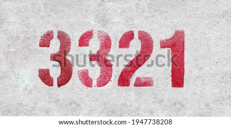 Red Number 3321 on the white wall. Spray paint.