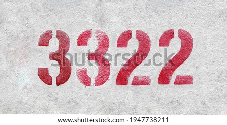 Red Number 3322 on the white wall. Spray paint.