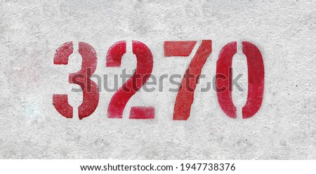 Red Number 3270 on the white wall. Spray paint.
