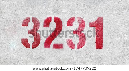 Red Number 3231 on the white wall. Spray paint.