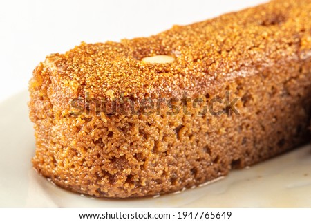 regional semolina damask dessert with almonds in a white plate close-up