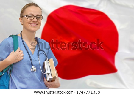 Female student doctor with stethoscope and books in hand on the Japan flag background. Medical education concept. Medical learning in Japan