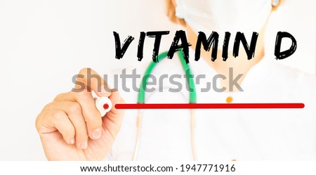 The doctor writes the text VITAMIN D with a marker. Medical.