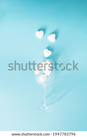 hearts going out of wine glass.minimal concept on a blue background