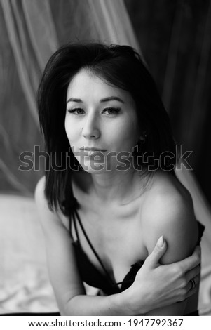 Portrait of beautiiful young woman on the black background.