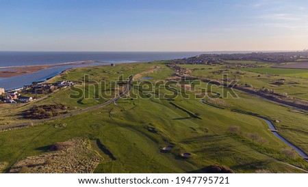 Drone point of view of a golf course by the coast in Felixstowe, Suffolk, UK Royalty-Free Stock Photo #1947795721
