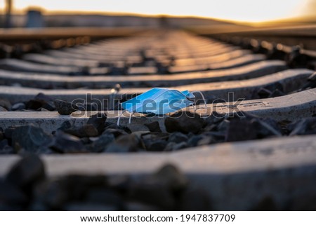 Blue medical mask lying on rails