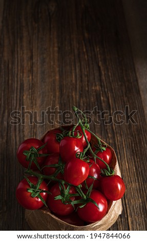 Fresh organic tomatoes in paper bag on the wooden table.Rustic food photography.Top view with copy space.
