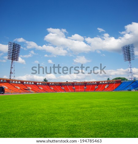 football field with green grass at sunny day