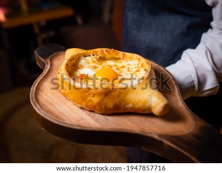 khachapuri traditional georgian cheese-filled bread with egg yolk and butter. georgian cheese bread 