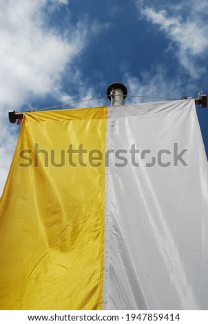 The yellow and white church flag of the Catholic Church is hoisted on many festive days such as First Communion, Confirmation, Easter, Pentecost and Christmas.
