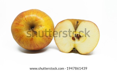 Apples. a whole yellow apple and a half apple