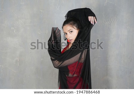 Woman dancer with cloth, face portrait in motion indoors