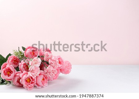 Abstract floral composition, spring background. Carnations on pink background, minimal holiday concept. Postcard for womens day or mothers day, happy birthday, wedding, banner