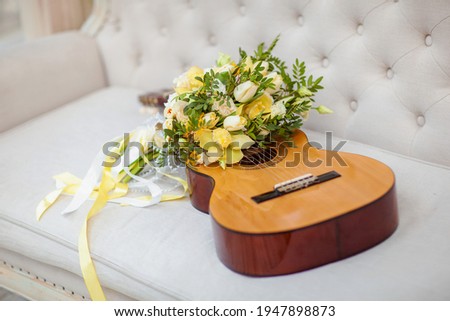 Guitar with elegant yellow bride's bouquet