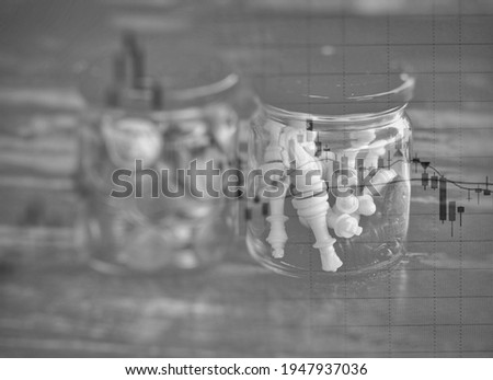 Stock market and Glass jar of Chess and Glass jar of coins 
and financial graph.business strategy as concept. Abstract business background.

