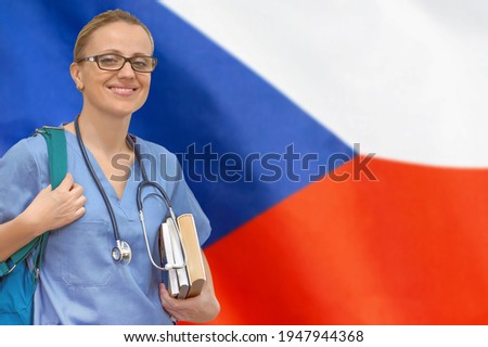 Female student doctor with stethoscope and books in hand on the Czech Republic flag background. Medical education concept. Medical learning in Czech Republic