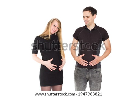 Photo of a pregnant blonde and a man standing on a white isolated background