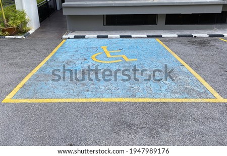 View of an old empty disabled car park in a outdoor parking lot (textured ground is not noise)
