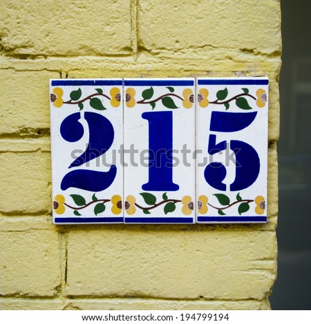 ceramic house number two hundred and fifteen, on three ceramic tiles