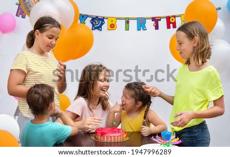 Kids birthday party eating cake at the table