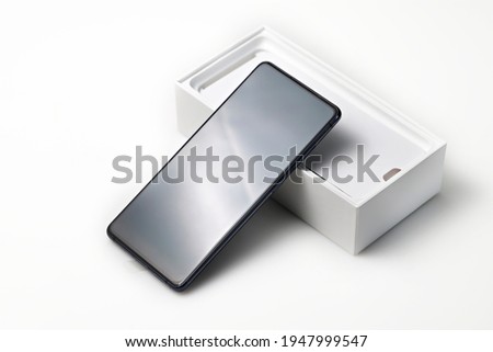 New smartphone with box isolated on white background. Royalty-Free Stock Photo #1947999547