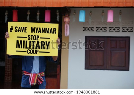 Asian man hold paper sign with text " # Save Myanmar stop nilitary coup". Concepr protest the violence from the coup in Myanmar. Royalty-Free Stock Photo #1948001881