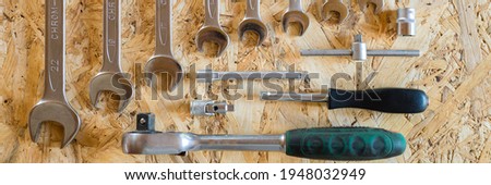 set of various repair hand tools or auto mechanic's tools. repair tool kit. equipment for building. wooden background, pattern, top view