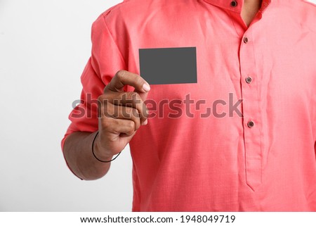Young indian farmer showing card on white background