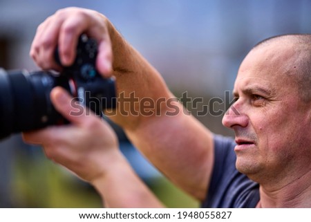 Close up profile portrait of photographer taking photo