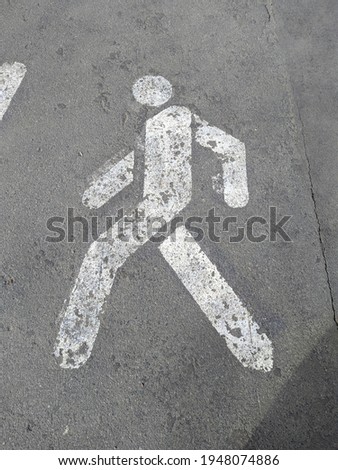 sign for walking on the asphalt in white that will be allowed to walk on the sidewalk