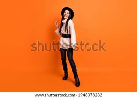 Full size photo of young gorgeous stunning positive woman dancing enjoying weekend isolated on orange color background