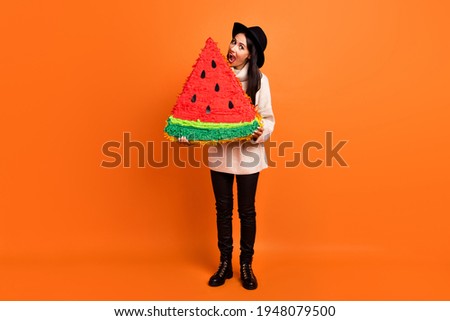 Full size photo of young beautiful funky funny crazy woman ear huge slice of watermelon isolated on orange color background