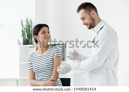 male doctor giving an injection to a woman vaccination health 