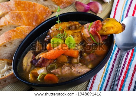 Scottish cuisine. Traditional chicken soup dish Cock-a-leekie with leeks in black plate.. Royalty-Free Stock Photo #1948091416